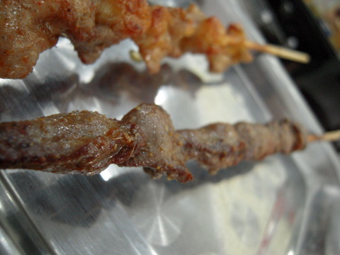 Chicken hearts on a skewer to the right, chicken cartilage (absolute DELICIOUS) on the left.
